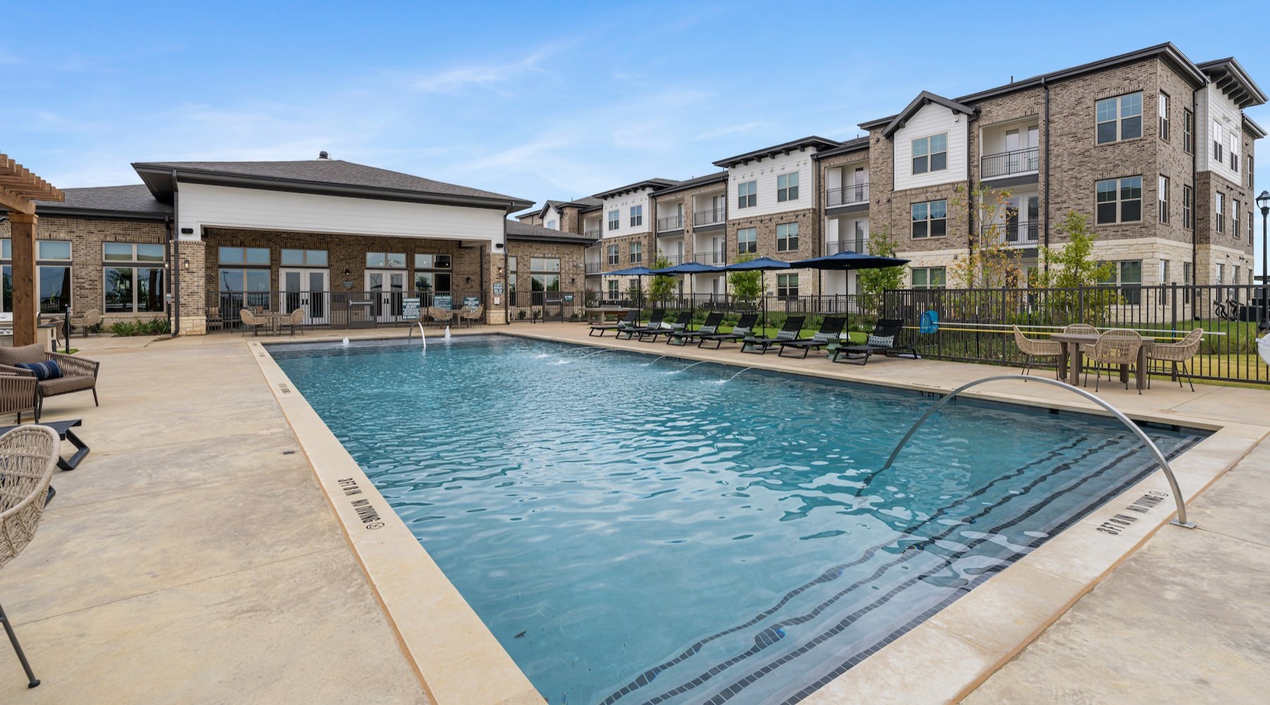 a swimming pool with buildings in the background