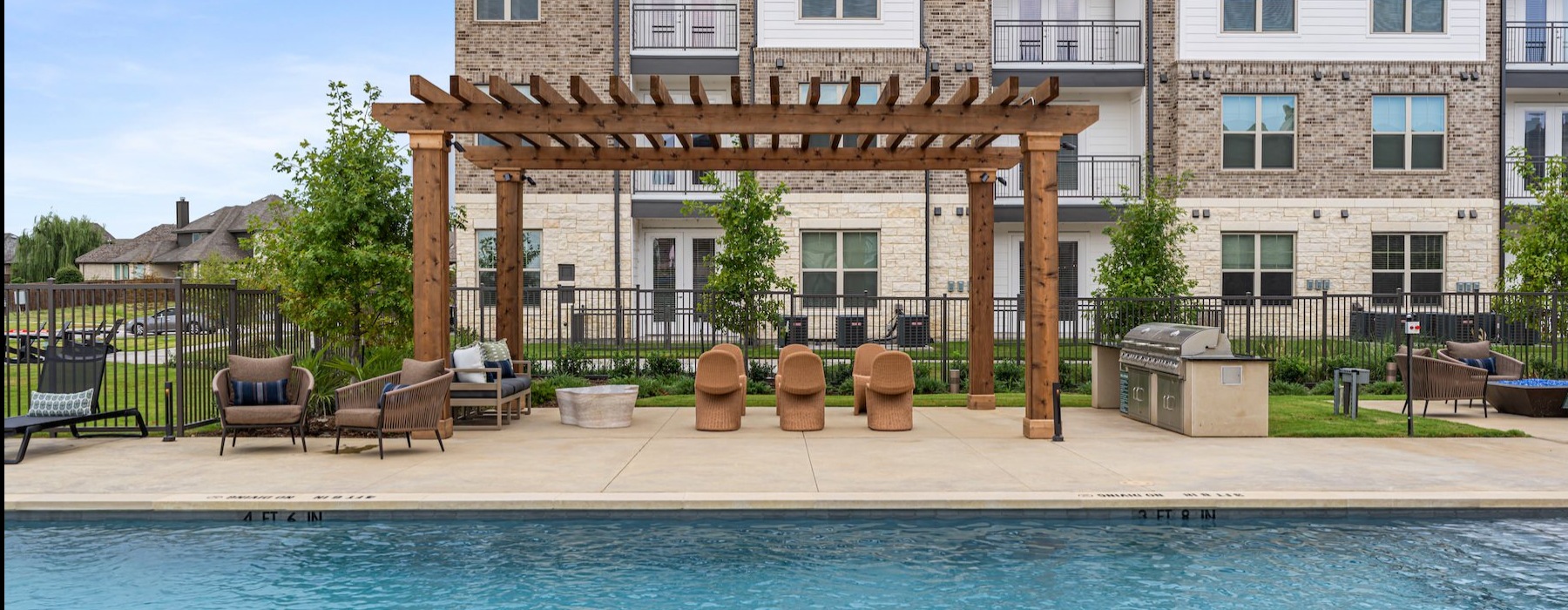 a swimming pool in front of a large building
